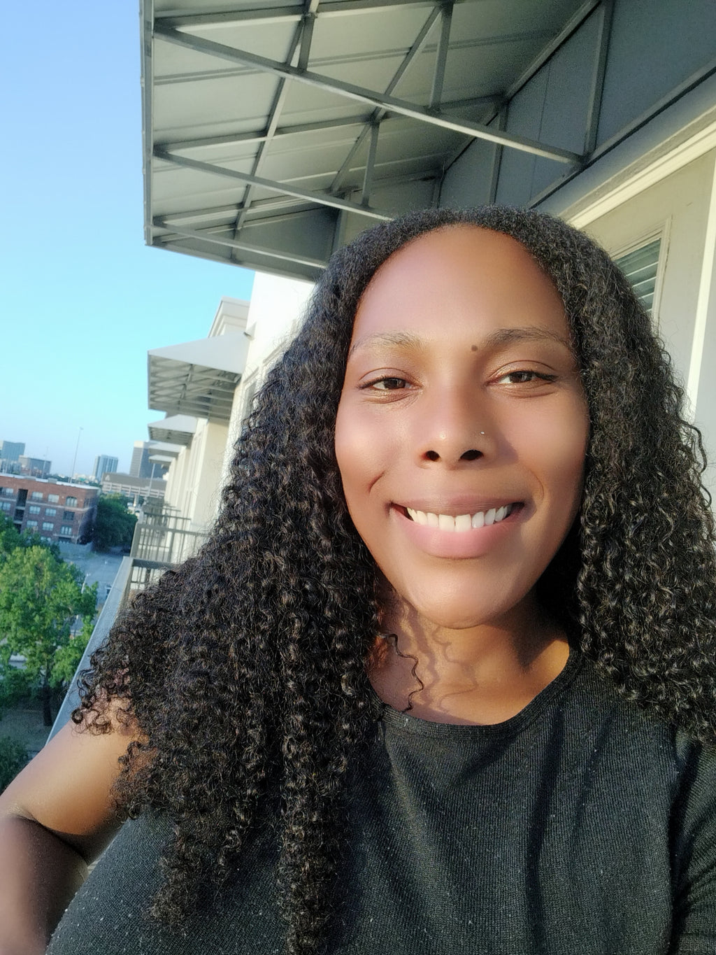 Close-up of kinky curly weft extensions showing defined 4B 4C curl pattern and natural density